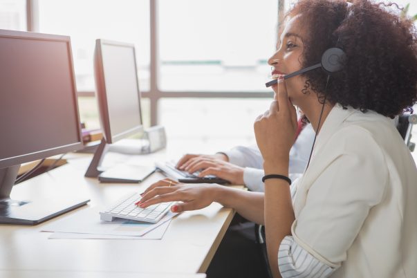 Customer engagement. A female call center employee is talking to a customer. She gives him good advice.